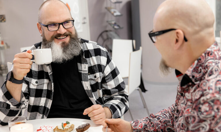Two men having coffee after a blood donation.