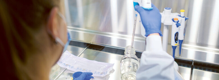 A researcher putting samples on a well plate.