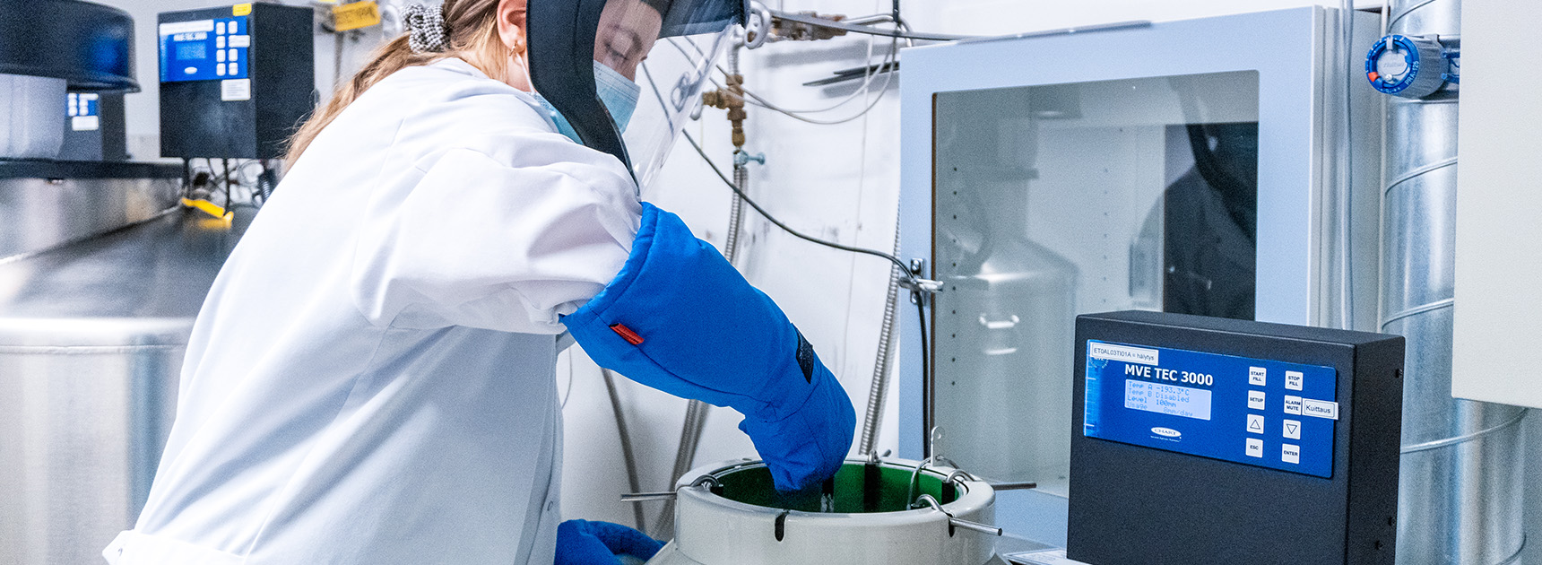 The employee places the samples in the liquid nitrogen storage container.