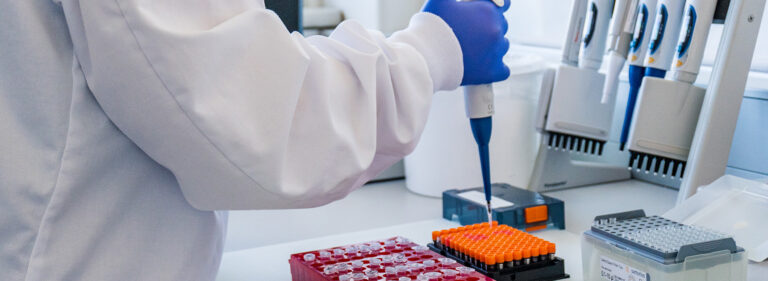 A researcher pipetting samples.